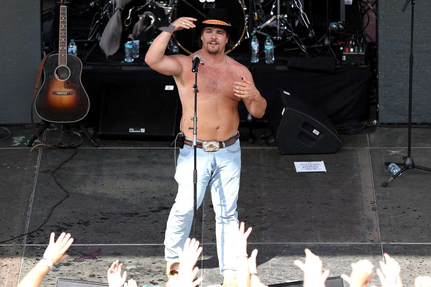 Nation singer Gavin Adcock falls off stage shirtless, loses hat throughout present: ‘It occurs’